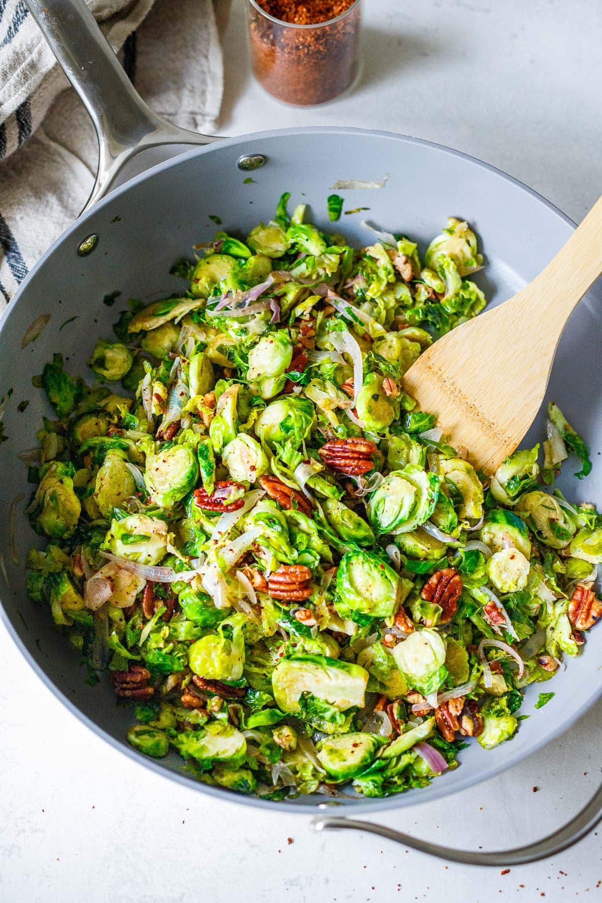 skillet with sauteed Brussels sprouts with shallots, pecans, and chili flakes. 