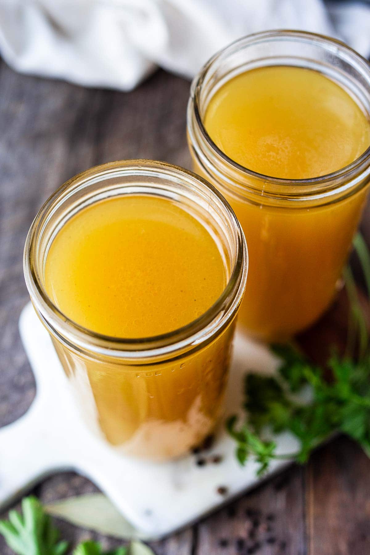 mason jars filled with chicken stock bone broth. 