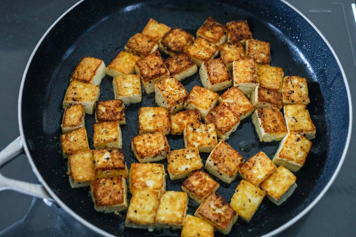 skillet with pan-fried tofu cubes.