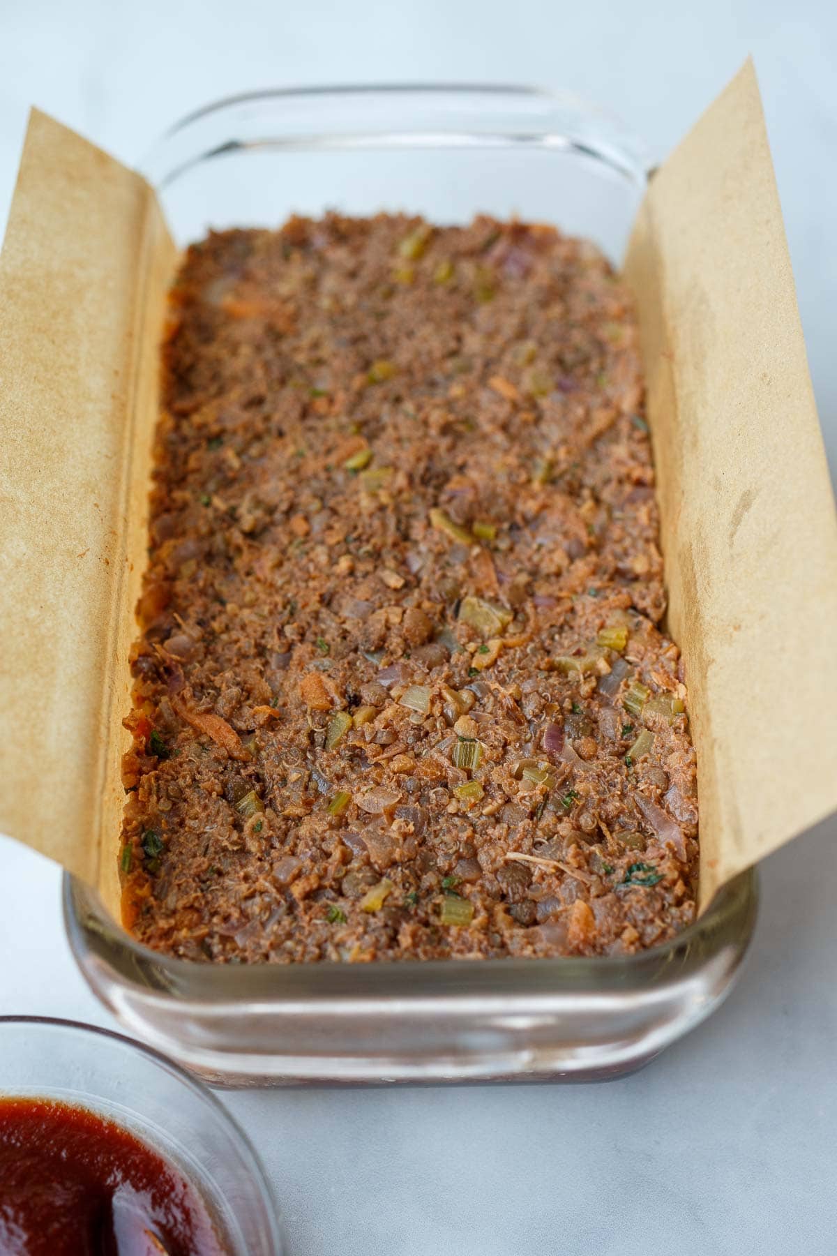 vegan lentil loaf pressed into loaf pan.