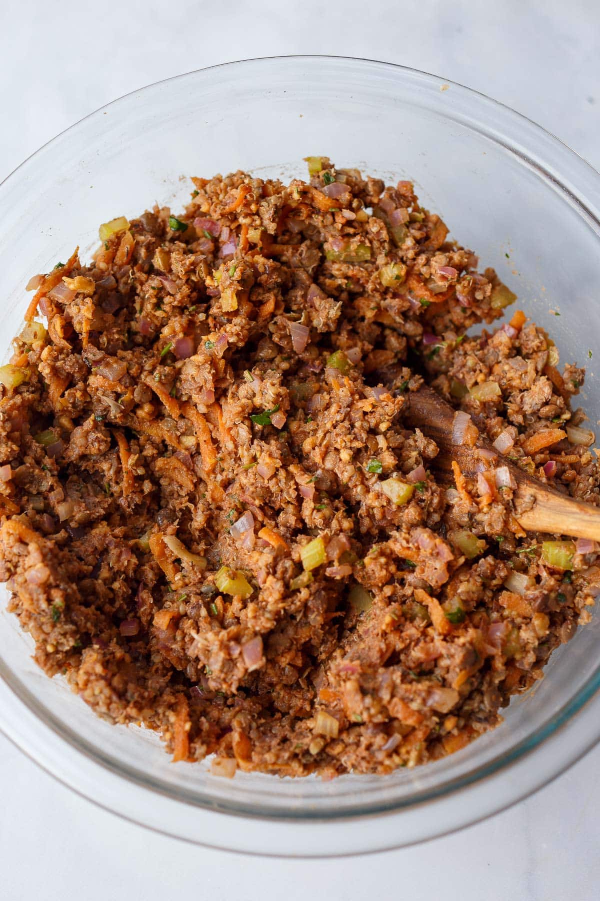 glass mixing bowl with lentil mixture for vegan meatloaf.