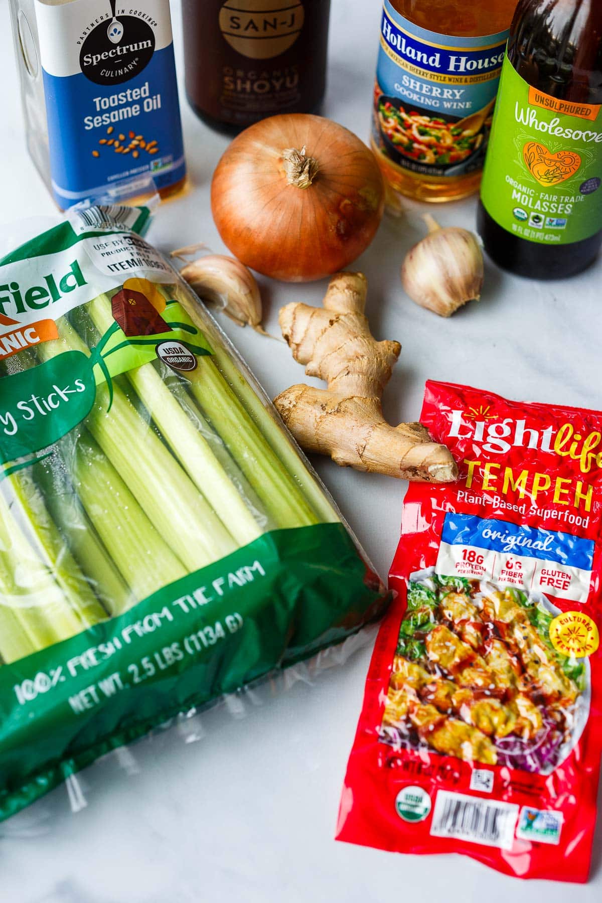 ingredients for celery stirfry- celery, tempeh, ginger, garlic, onion, molasses, sherry cooking wine, tamari, and toasted sesame oil. 