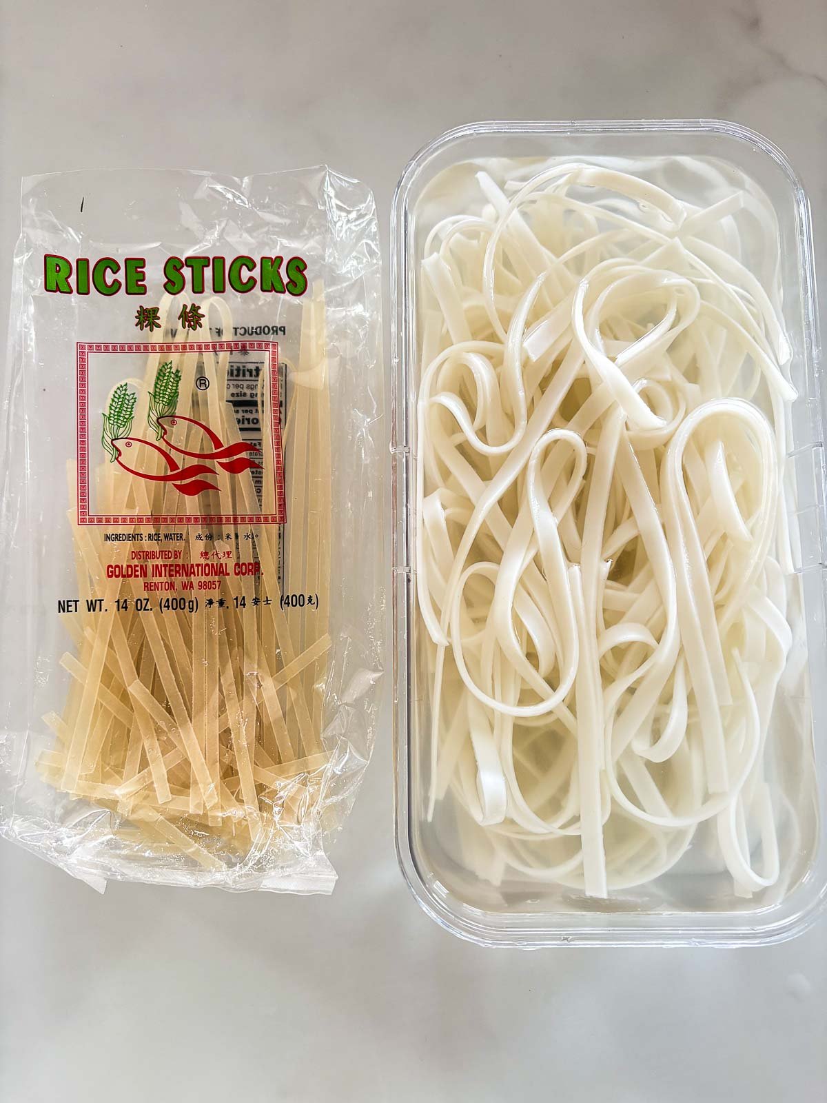 rice sticks softening in glass container of water.