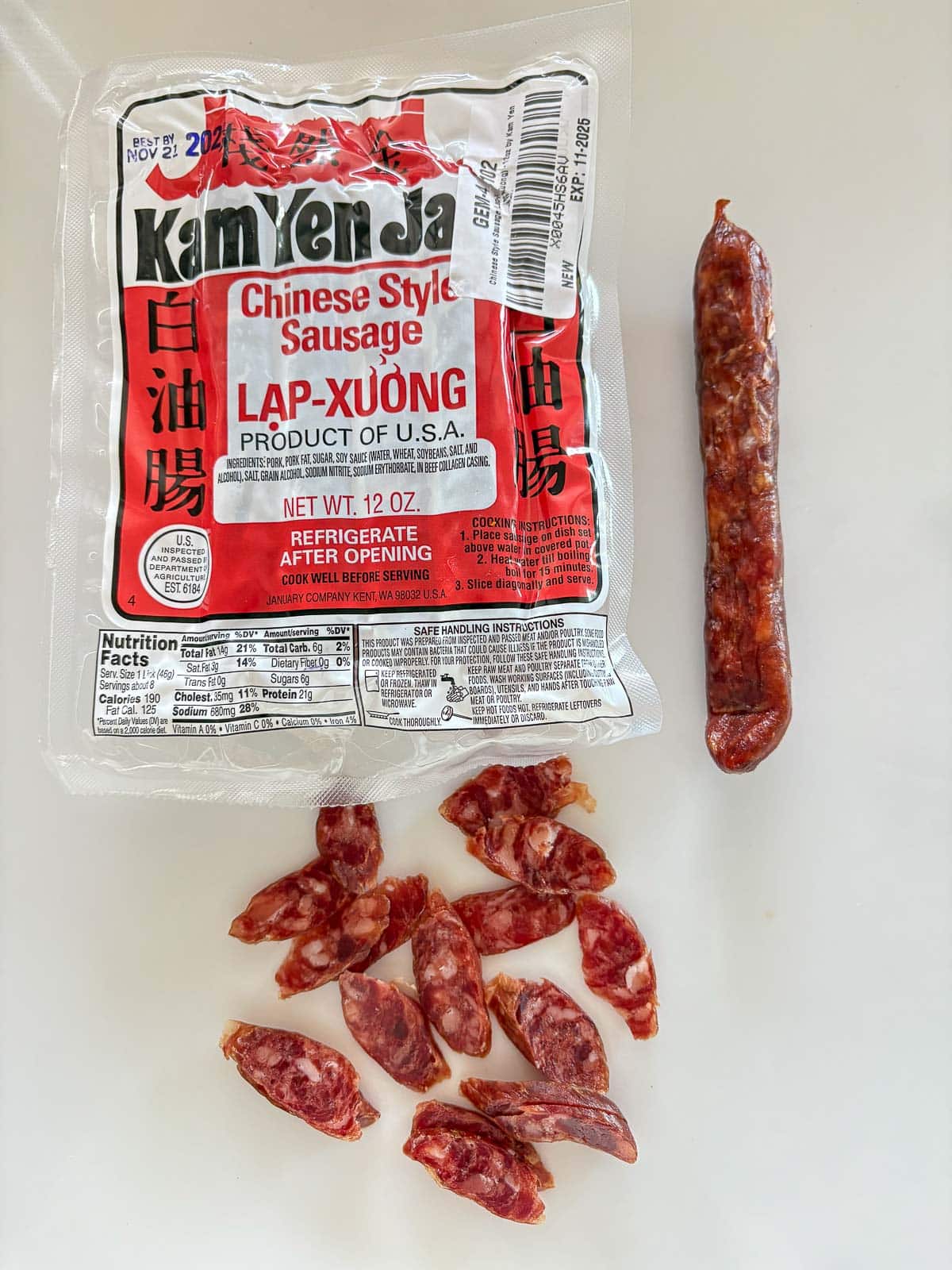 package of Chinese style sausage with a piece laid out and another piece sliced thinly.