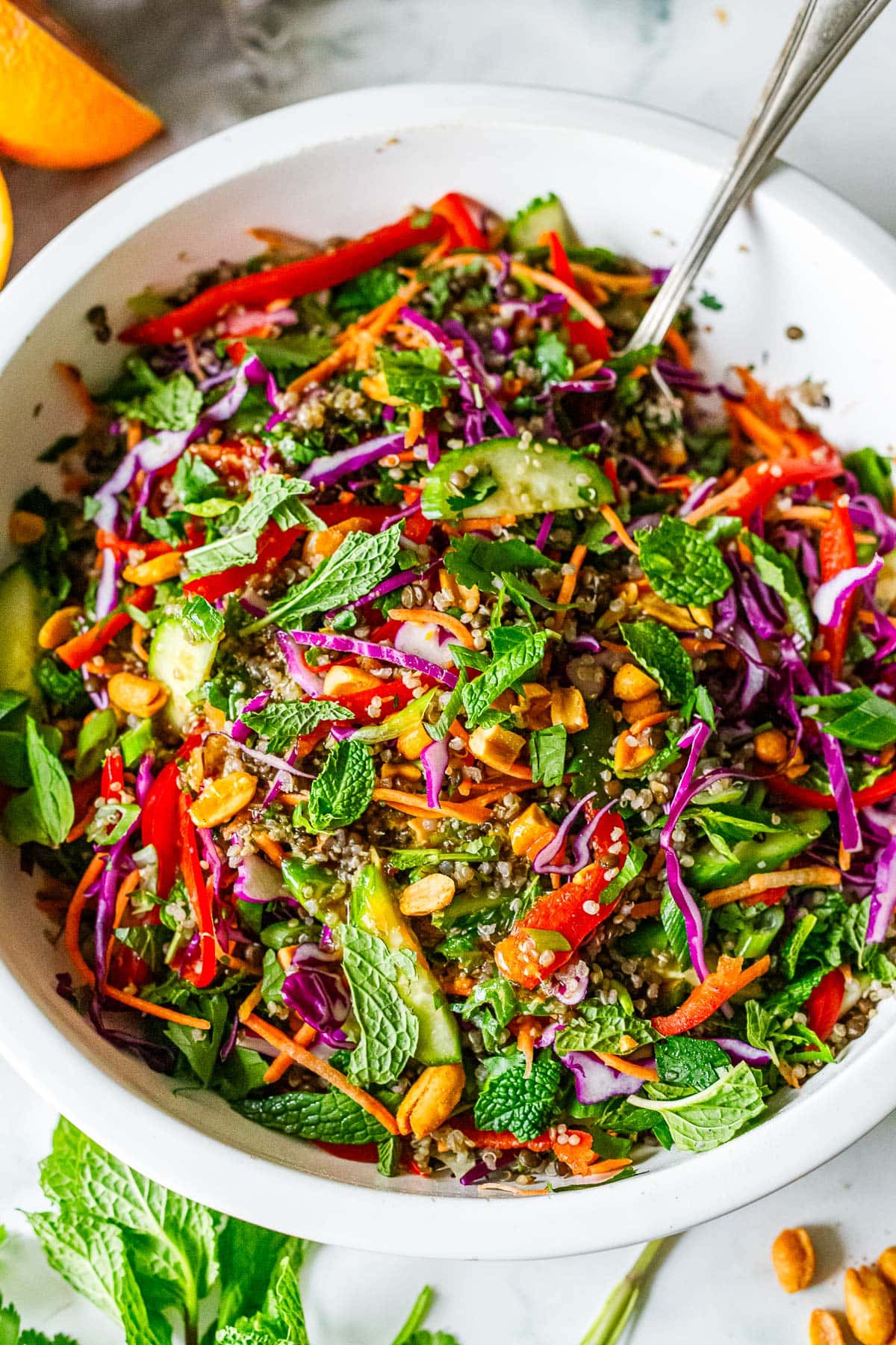Thai lentil quinoa salad in a bowl wtih mint and peanuts.