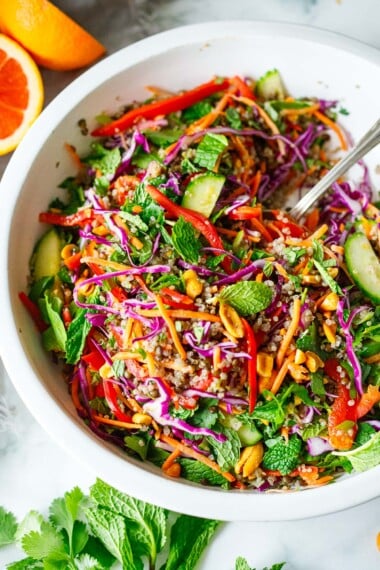 This bright and cheery Lentil Quinoa Salad is packed with Thai flavor! Crunchy veggies and fragrant herbs in a tangy Thai Dressing. Vegan & gluten-free.