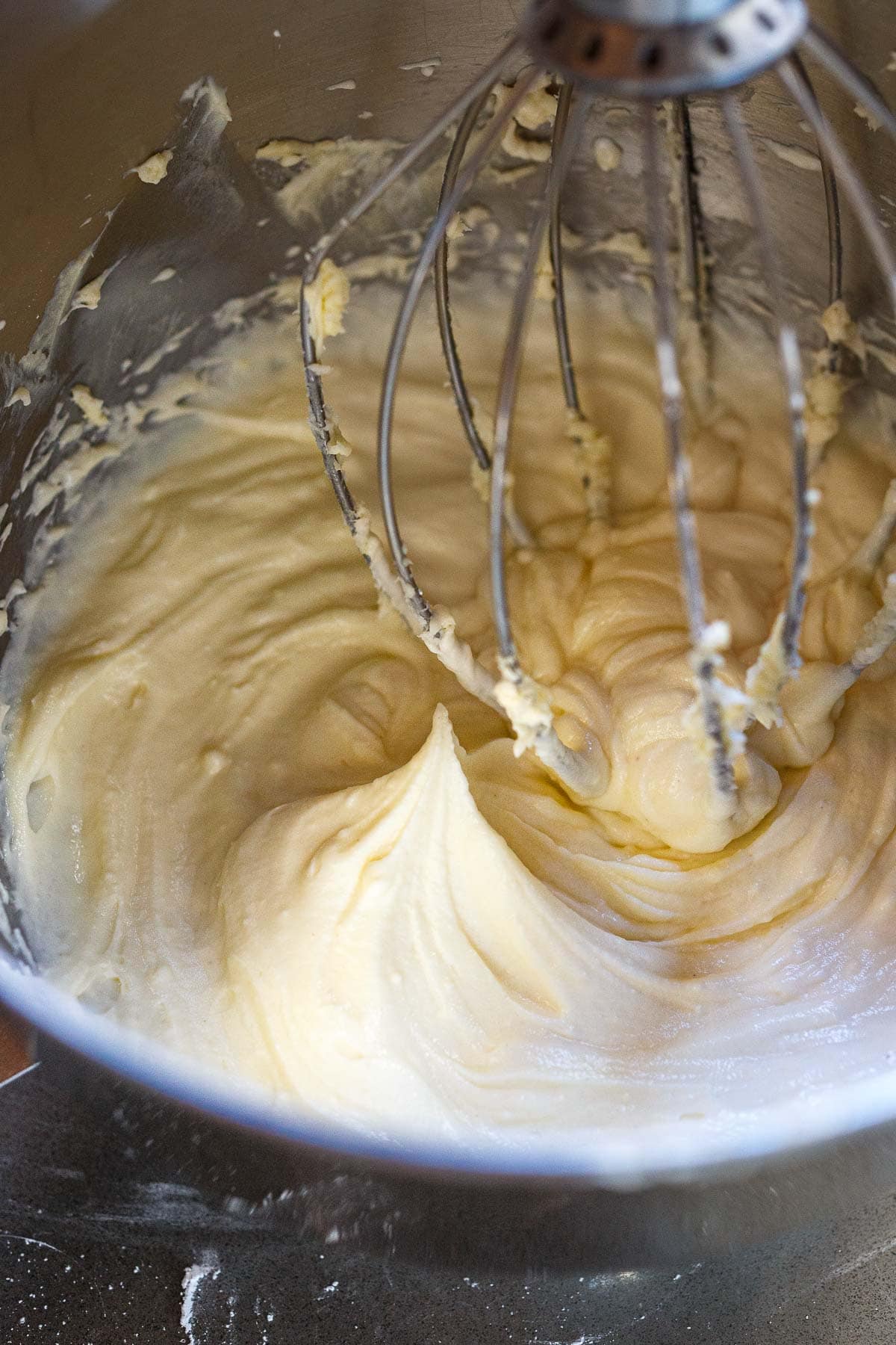 light and fluffy cream cheese frosting in bowl of stand mixer.