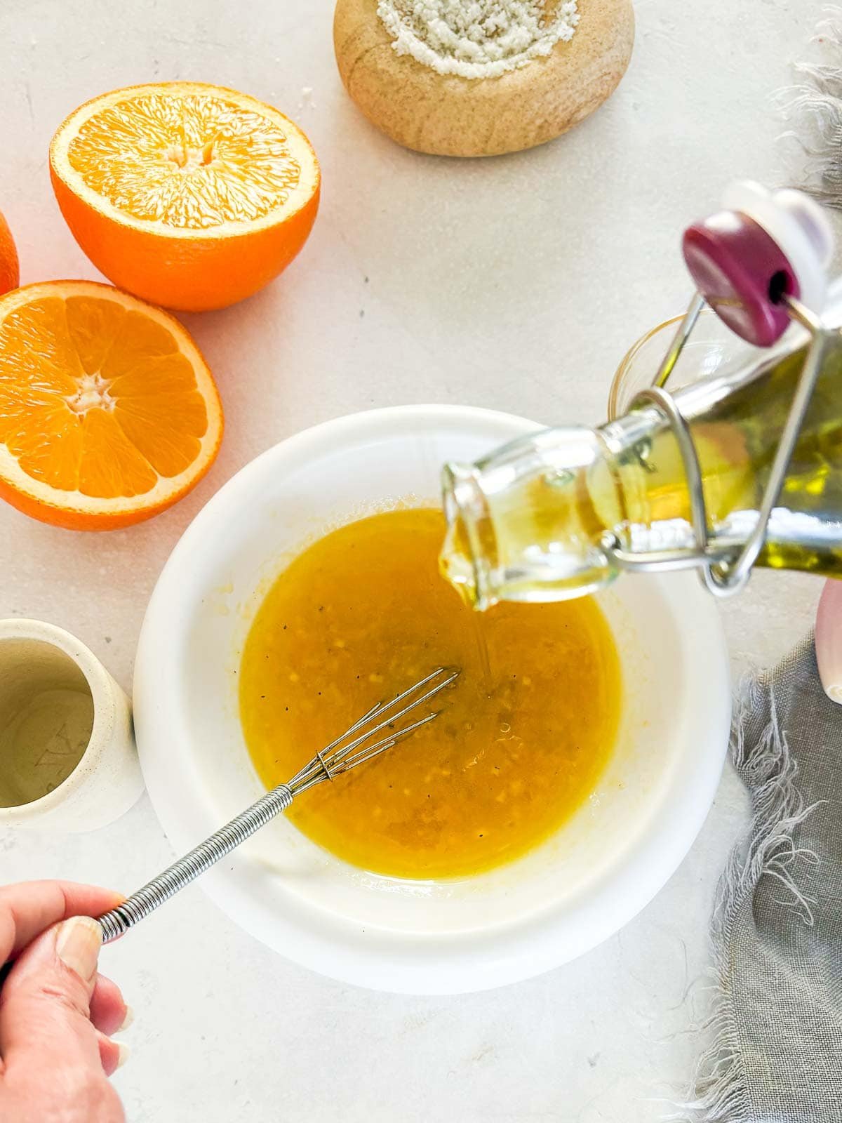 streaming in the olive oil and whisking the dressing.