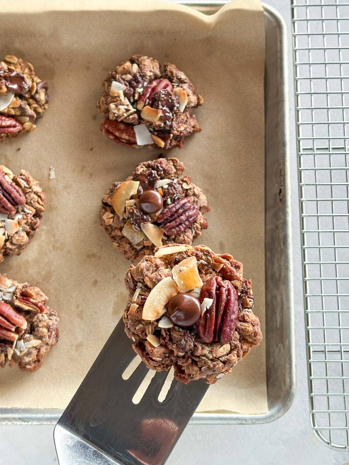 moving cowboy cookies to a wire cooling rack.