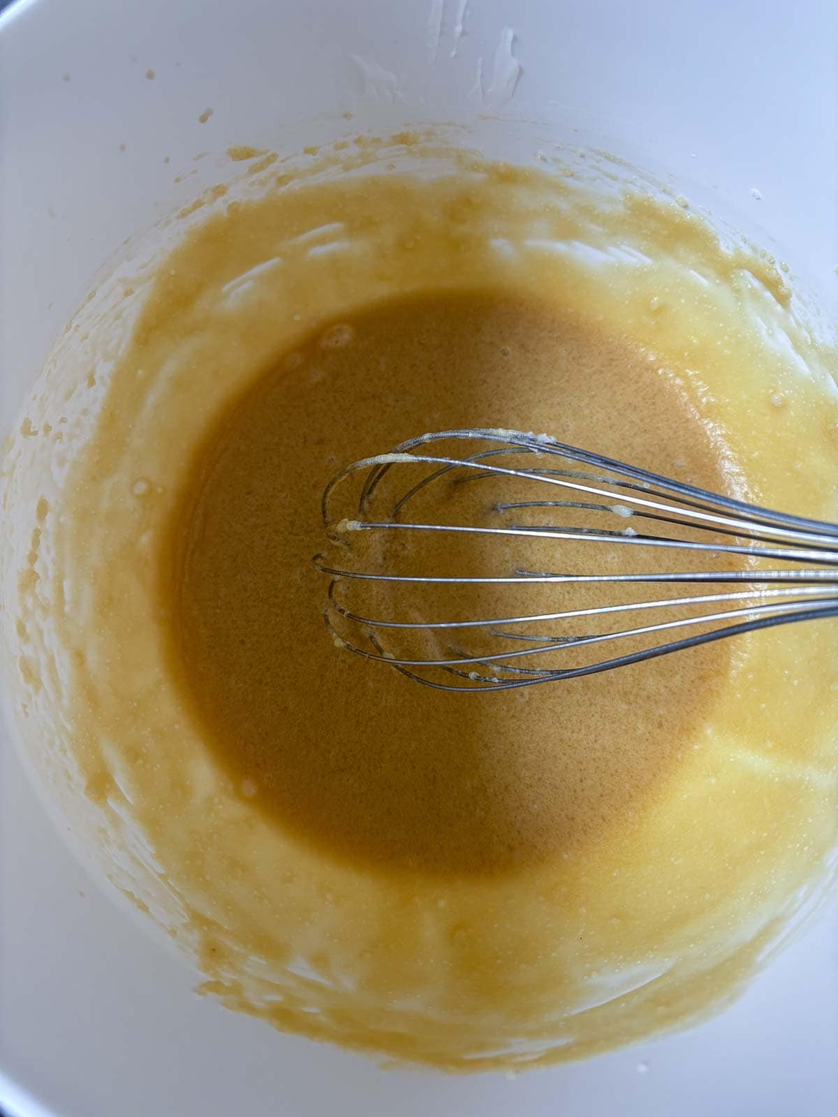 mixing bowl with cowgirl cookies batter and a whisk.