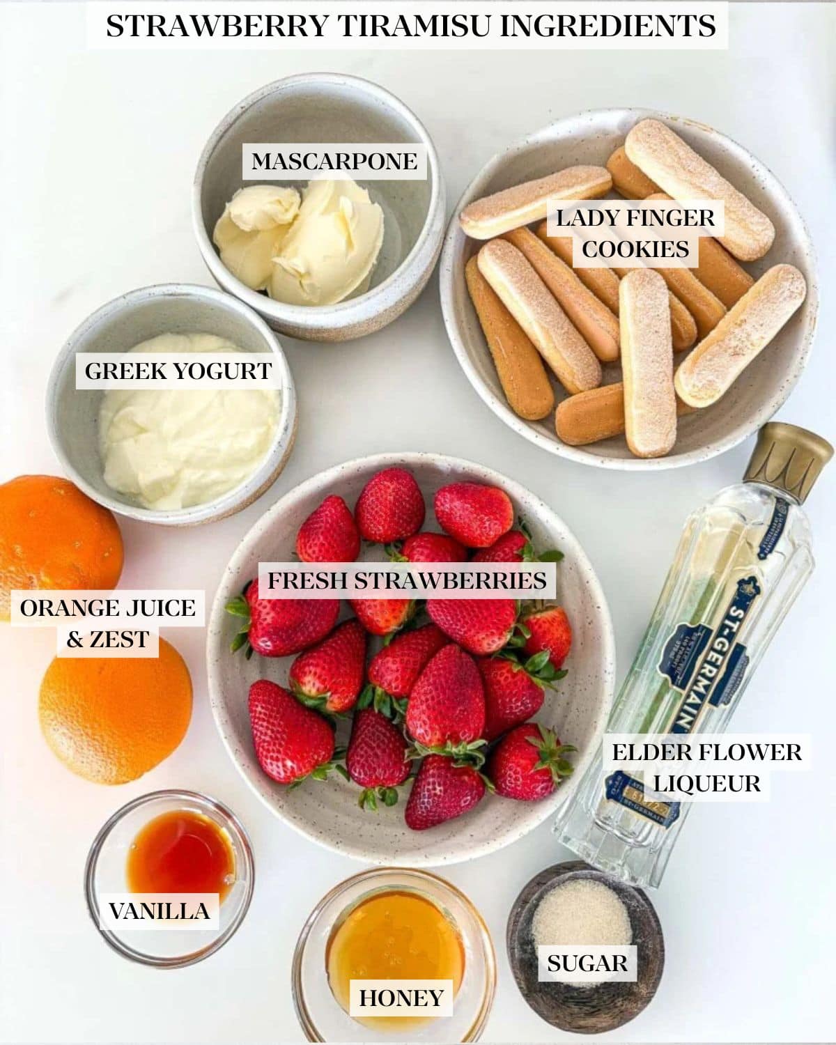 ingredients for strawberry tiramisu - ladyfingers, mascarpone, yogurt, oranges, strawberries, st. germain, vanilla, honey, sugar arranged neatly in bowls.