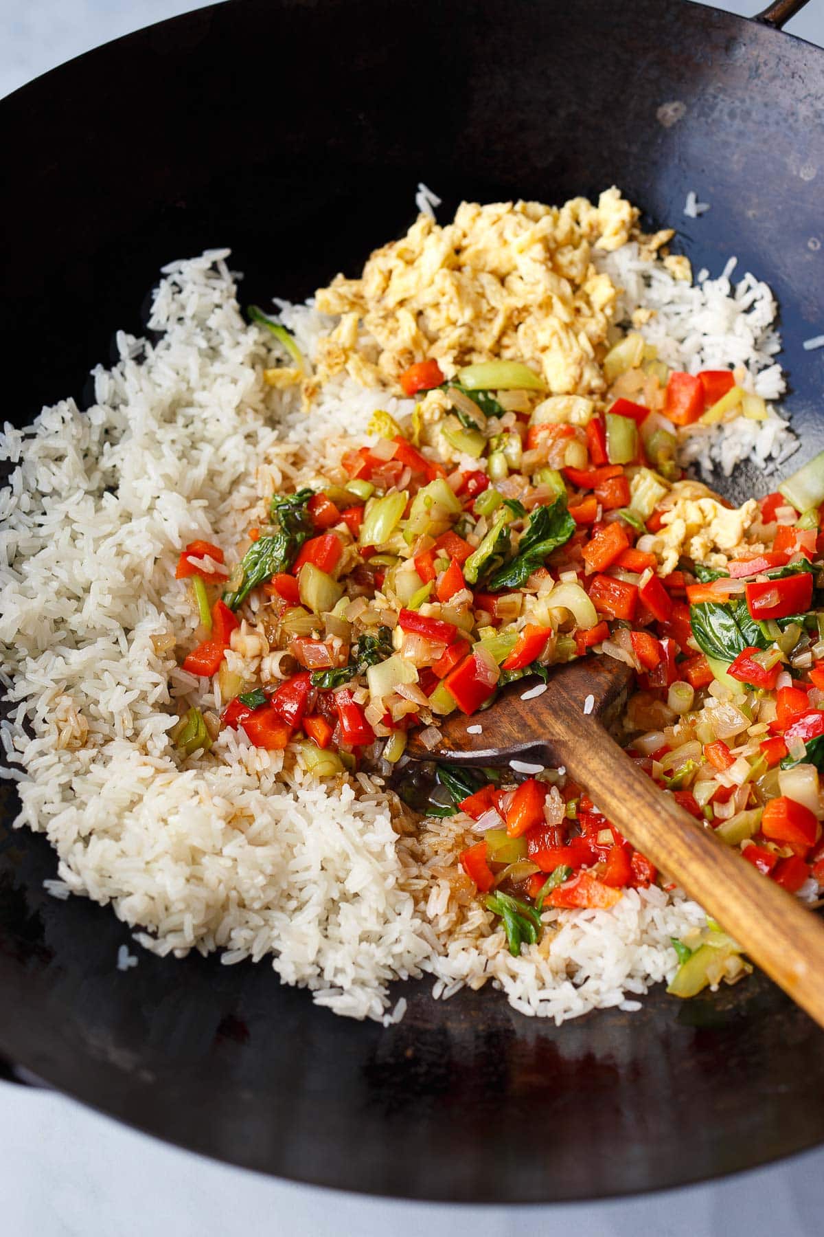 wok with all ingredients added - jasmine rice, stir-fried veggies, scambled eggs.