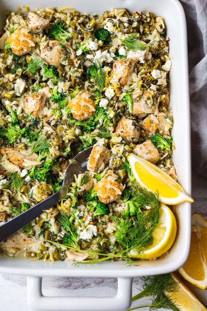 Cozy one-pan Chicken Orzo Bake with broccoli, feta, and lemon is easy and delicious! A comforting weeknight dinner, ready in under an hour!