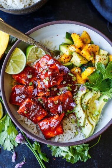 Spicy sticky gochujang-glazed salmon meets cool mango-cucumber salsa in this bold, Korean-inspired rice bowl. Served with jasmine rice and creamy avocado, it’s a healthy, flavor-packed meal perfect for weeknights.